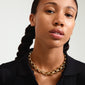 Close-up of a woman wearing the Pilgrim gold-plated DUNE necklace featuring chunky links, highlighting its chic and trendy design.