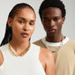 Man and woman showcasing Pilgrim's DUNE gold-plated necklace with chunky links, exemplifying urban fashion trends and sustainable design with 99% recycled material.