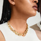 DUNE gold-plated necklace on a woman, featuring chunky links and a shiny finish, embodies Pilgrim's blend of timeless and trendy Scandinavian design.