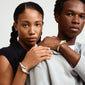 Silver-plated DUNE bangle on a woman's wrist, showcasing its dynamic, uneven design. A bold, handcrafted accessory for a personalized style statement.