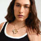 TIDE heart necklace gold-plated by Pilgrim, featuring a bold curb chain and chunky heart pendant, worn by a woman, showcasing its handcrafted design and unique style.