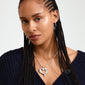 TIDE heart necklace silver-plated on a woman with braided hair, showcasing a bold curb chain and chunky heart pendant, emphasizing Pilgrim's handcrafted Danish design.