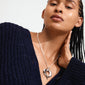 Close-up of a woman wearing the silver-plated TIDE heart necklace by Pilgrim, featuring a chunky heart pendant and bold curb chain.