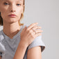 TRUST ring 3-in-1 set silver-plated: Woman wearing a grey shirt, showcasing a close-up of stacked rings featuring a red Agate stone and white glass beads.