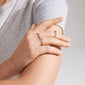 Close-up of hands showcasing Pilgrim's TRUST 3-in-1 silver-plated ring set, featuring a red Agate stone, white glass beads, and an adjustable simple ring.