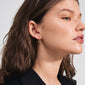 FEEL earrings gold-plated, showcasing stylish rectangular hoops worn by a woman. These eco-friendly, minimalist earrings add a chic touch, perfect for a modern, urban look.