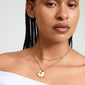 Woman wearing Pilgrim's DAWN necklaces, a 2-in-1 gold-plated set with a unique coin pendant, showcasing a trendy, layered look.