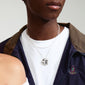 Man wearing Pilgrim's DAWN necklace, a 2-in-1 silver-plated set with a coin pendant and curb chain, highlighting modern, handcrafted design.