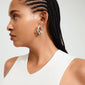 Close-up of a woman wearing Pilgrim's DAWN silver-plated hoop earrings, showcasing their elegance and contemporary style.