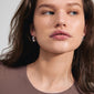 Close-up of a woman wearing Pilgrim's INTENT earrings, showcasing silver-plated semi-hoops with a shiny, chunky finish, embodying modern elegance and style.