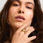 Gold-plated SUNSET ring with organic design and Preciosa crystals on woman's finger, showcasing elegance and style. Perfect for trendsetters seeking sophistication.