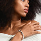 SUNSET bracelet silver-plated displayed on a woman's wrist with curly hair, highlighting its unique organic design and sleek, hidden clasp for a secure fit.