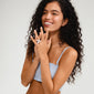 Woman wearing a silver-plated DREAM statement ring with a large floral design, showcasing its bold style and adjustable fit, aligning with Pilgrim's trendy aesthetic.