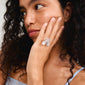 Woman with curly hair wearing the DREAM statement ring, a silver-plated floral design by Pilgrim, highlighting modern Scandinavian jewelry craftsmanship.