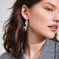 JUDE silver-plated earrings by Pilgrim, featuring an organic design with pearlescent glass beads, worn by a woman with long brown hair.