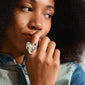 Woman with curly hair wearing the Pilgrim RYAN silver-plated statement ring, featuring a bold heart design, highlighting her individual style and the brand's trendy craftsmanship.