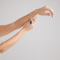 Close-up of a hand wearing a silver-plated CHARM black agate pendant bracelet, showcasing Pilgrim's unique and personal style statement.