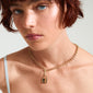 Gold-plated CHARM locket pendant by Pilgrim, worn by a woman with short red hair, showcasing its edgy padlock design ideal for personal style statements.