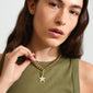 Close-up of a woman wearing the CHARM starfish pendant, a gold-plated necklace adorned with Preciosa crystals, highlighting Pilgrim's unique, trendy jewelry style.