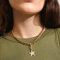 Woman wearing Pilgrim's CHARM starfish pendant, gold-plated, with sparkling Preciosa crystals, highlighting a trendy and unique personal style.