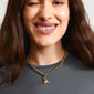 Woman smiling, wearing the CHARM elephant pendant gold-plated, featuring a whimsical elephant charm with sparkling Preciosa crystals, exemplifying Pilgrim's playful, eco-conscious jewelry style.