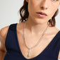 Woman wearing Pilgrim's silver-plated CHARM shell pendant, styled as a necklace. The pendant adds a personal, seaside-inspired touch, crafted from 99% recycled material.