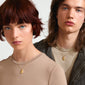 A man and woman showcase the CAPRICORNUS Zodiac Sign necklace, gold-plated, featuring a dual-design pendant with a Capricorn motif and sparkling constellation.