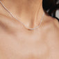 Silver-plated 'HOPE' necklace with a cursive pendant, worn by a woman. A sleek, genderless piece ideal for daily wear and gifting.