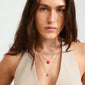 MAEVE necklace, 2-in-1 gold-plated set, shown on a woman with long brown hair, featuring a heart pendant, highlighting Pilgrim's chic, eco-friendly design.