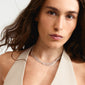 KIRA necklace silver-plated on a woman in a white dress, featuring layered flat snake chains for a unique, sculptural look.