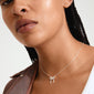 CASSIAN necklace silver-plated: Woman showcasing a silver bow pendant on a slim box chain, highlighting Pilgrim's sleek, trendy design.