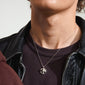 Person wearing the LUCA necklace silver-plated, featuring a round, shiny pendant with an organic melting shape, highlighting its unique character and eco-friendly design.