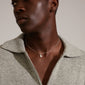 Man wearing Pilgrim's CARLA pendant necklace, silver-plated with light chain and organic pendant, showcasing a stylish, handcrafted look.