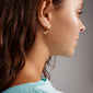 Close-up of a woman's ear featuring the gold-plated HALLIE hoop earrings from Pilgrim, showcasing their elegant and minimalist design.