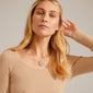 CHANTAL pendant necklace: Silver-plated, adjustable length, featuring a shiny, organic-shaped pendant worn by a woman in a tan sweater.