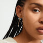 IMOGENE gold-plated earrings with sparkling Preciosa crystal pendants, worn by a woman with long black braids. Stylish, recycled, and perfect for elevating any party look.