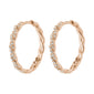 EZO twirled crystal hoops rosegold-plated with twisted design and Preciosa crystals, featuring a smart click clasp. Perfect for an elegant, confident look.