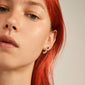 EILISH huggie hoop earrings & studs 2-in-1 silver-plated, showcased on a woman with red hair, highlighting the earrings' curved crescent shape.