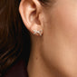 Silver-plated CATHARINA earrings featuring sparkling bow design, close-up on a woman's ear, showcasing trendy, recycled body jewelry with Preciosa crystals.