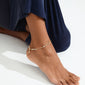 SLOAN ankle chain gold-plated, featuring white freshwater pearls and glass beads, elegantly adorns a person's ankle, embodying Pilgrim's classic style.