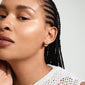 JUA gold-plated earrings in a chunky, bubble dome design adorn a woman's braided hair, highlighting Pilgrim's blend of classic and trendy styles.