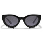 ALONDRA sunglasses black by Pilgrim, featuring a bold cat-eye-inspired design with black lenses, crafted from recycled plastic for a distinctive, eco-friendly style.