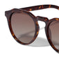 ALEJANDRA sunglasses in tortoise brown, featuring a unique angular round design, offering UVA/UVB protection. Comes with a protective fabric pouch.