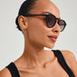 Woman wearing ALEJANDRA sunglasses in tortoise brown, showcasing their angular upper frame design, highlighting Pilgrim's stylish and protective eyewear.