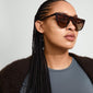 ALESSANDRA sunglasses tortoise brown on a woman, featuring a sleek, horizontal frame that exudes empowerment and style, perfect for fashion-forward individuals.