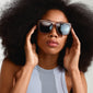 A woman with an afro wearing Pilgrim's ANIYAH sunglasses in a bold, angular design, showcasing fashion-forward eyewear.