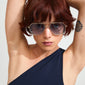 Woman with short red hair wearing ANA sunglasses grey/gold by Pilgrim, featuring a sleek, angular Pilot-style metal frame, embodying cool, classy style.