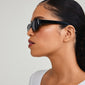 AINSLEY sunglasses black: woman modeling slim black sunglasses with chunky temples and rectangular frame, exuding retro vibes, perfect for stylish summer outings.