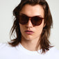 VANILLE sunglasses brown/gold featuring slim, gold-plated temples and a sleek, transparent dark brown frame, worn by a man with long hair and sunglasses.