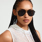 Woman wearing ANA sunglasses by Pilgrim with sleek metal frame and angular design, embodying a cool, classy look.